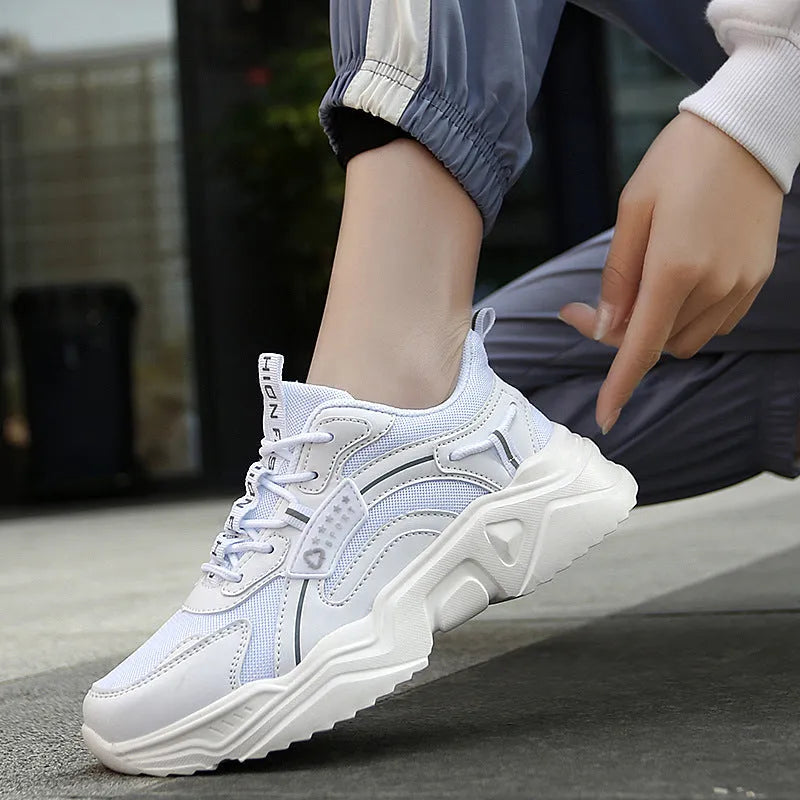 Women's white casual sports shoes with mesh upper, thick PU sole, and buckle detail