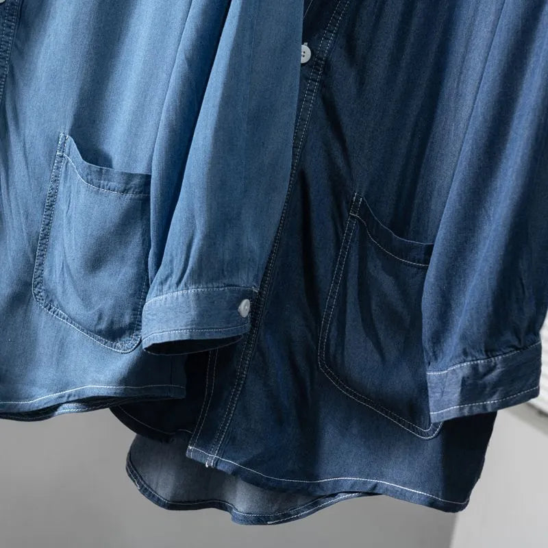 Men's dark blue denim coat with three-quarter sleeves and V-neck collar showing front pocket detail