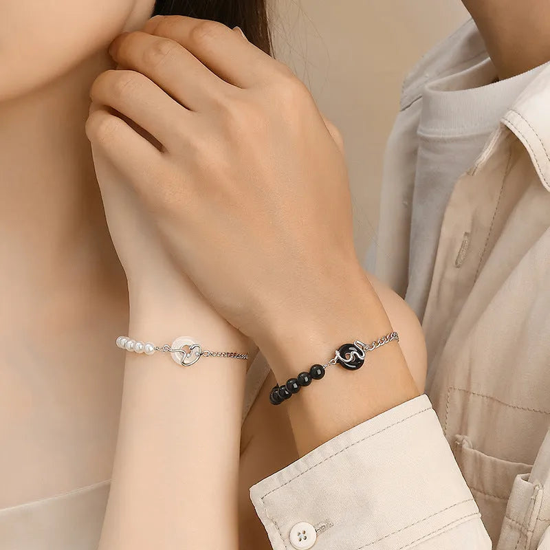 925 sterling silver couple bracelet with safety buckle, obsidian pearl, and Chinese zodiac snake design.
