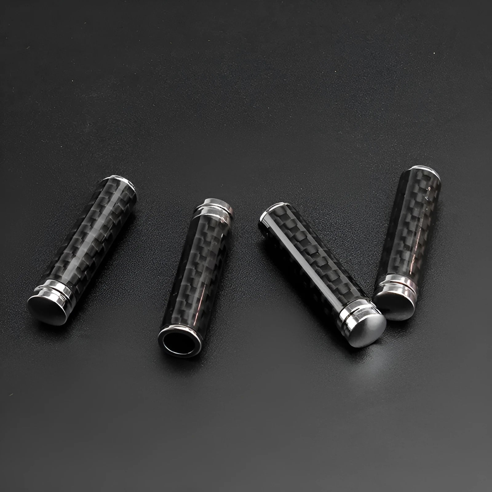 Set of four carbon fibre and metal car door lift decorative covers for direct replacement installation.