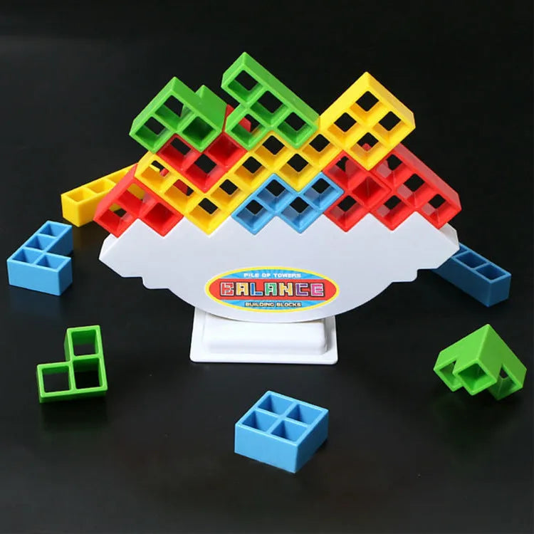 Plastic balance stacking game with colourful blocks, chassis, and base in packaging.