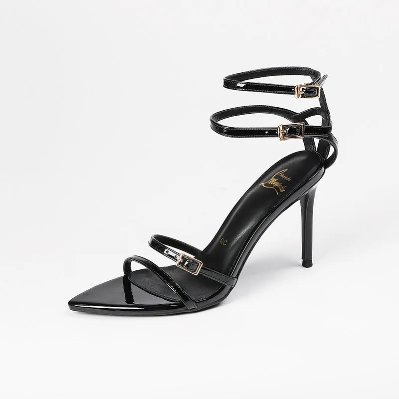 Black patent leather women's ankle-strap stiletto sandals with open toe and 8cm heel on a white background