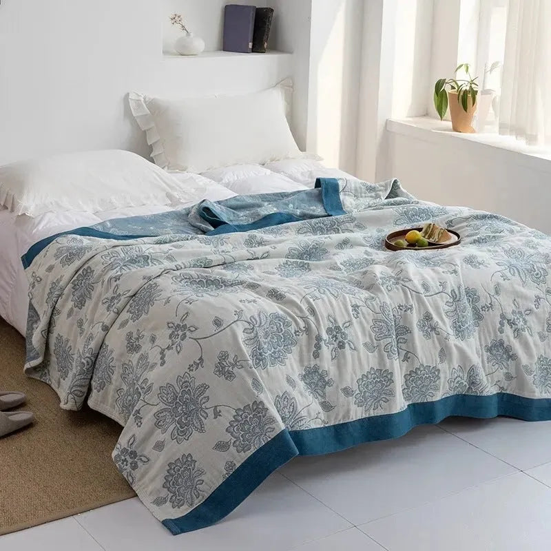 Five-layer thickened pure cotton gauze bed blanket in Roulette Wheel Blue pattern on bed