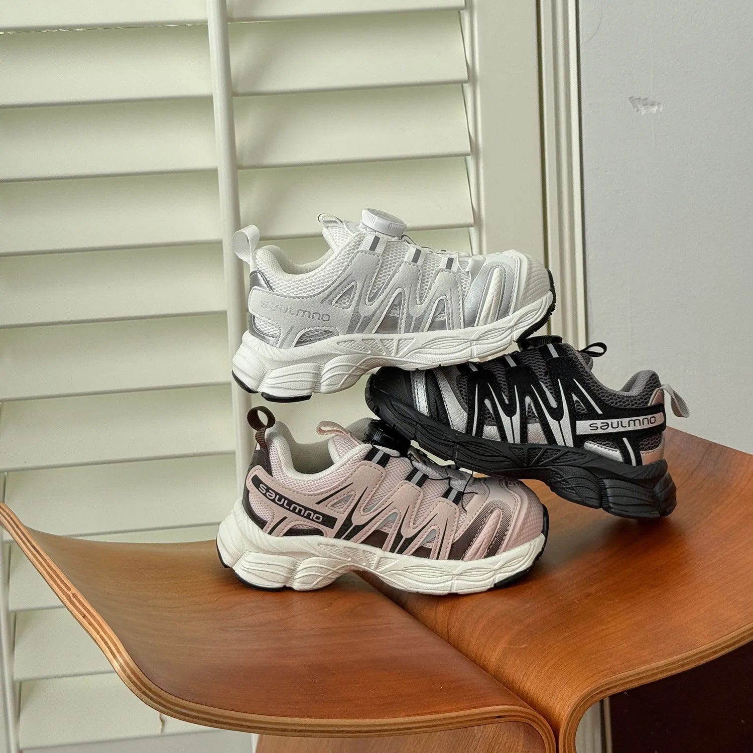 Girls' casual shoes with PU leather mesh upper in black, beige or pink colours on solid background