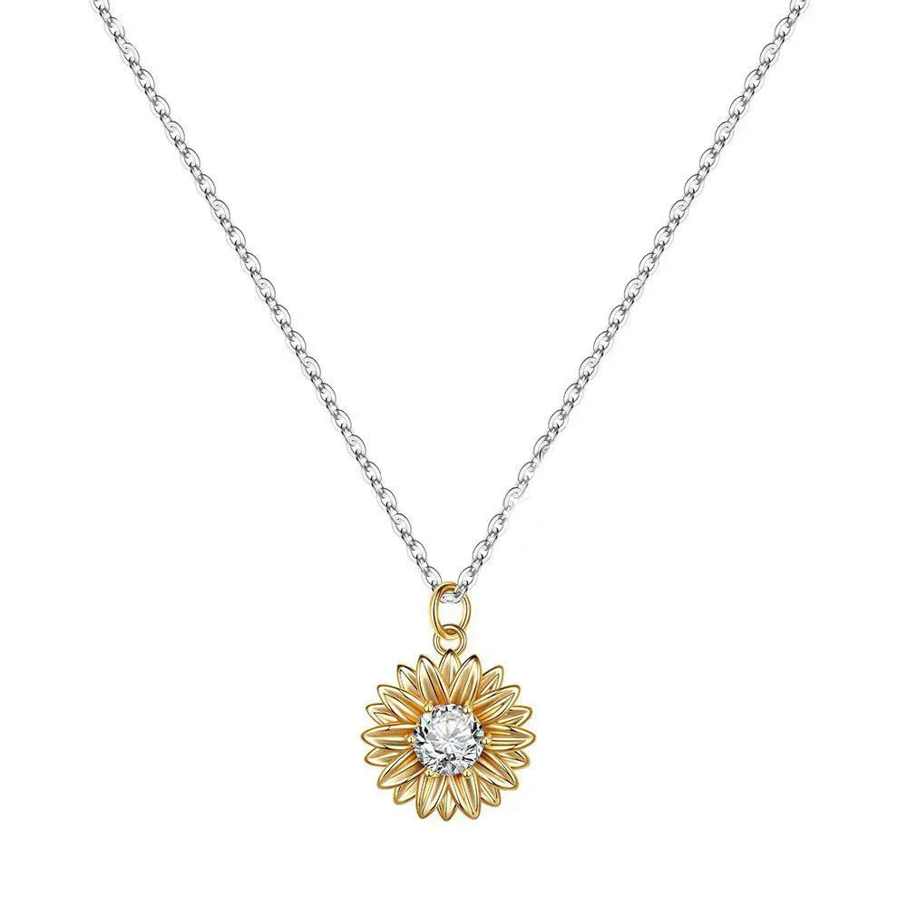 Close-up of a sterling silver sunflower necklace with geometric daisy pendant on an adjustable cross chain.
