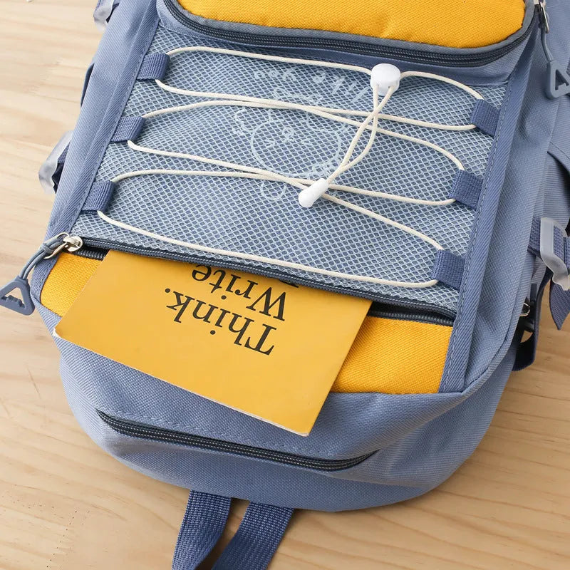 Solid colour nylon school backpack with curved shoulder straps, shown in black, blue, pink, and purple options.