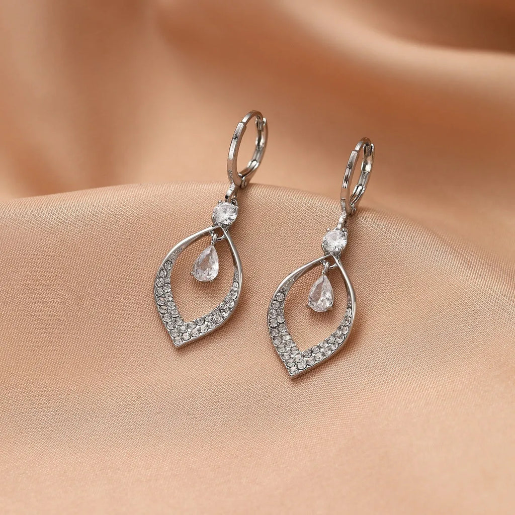 Gold zircon teardrop tassel earrings with electroplated copper construction.