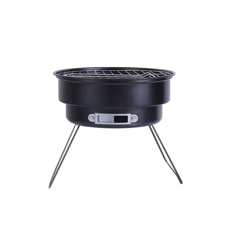 Small metal round folding ice stove with grill mesh and legs set up for barbecue.