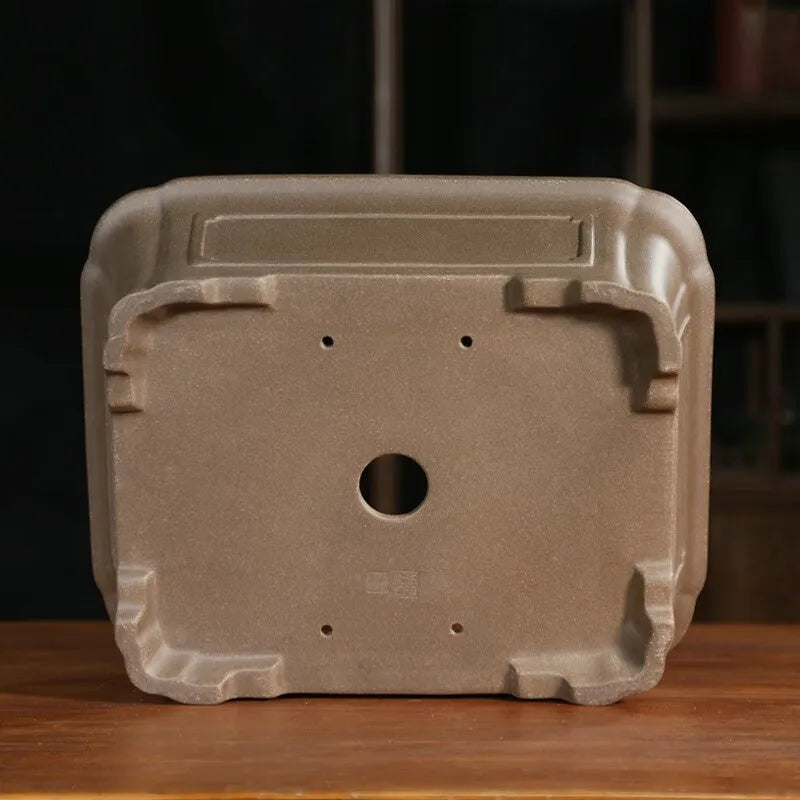 Classical rectangular purple sand bonsai pot with cut corners on a floor.