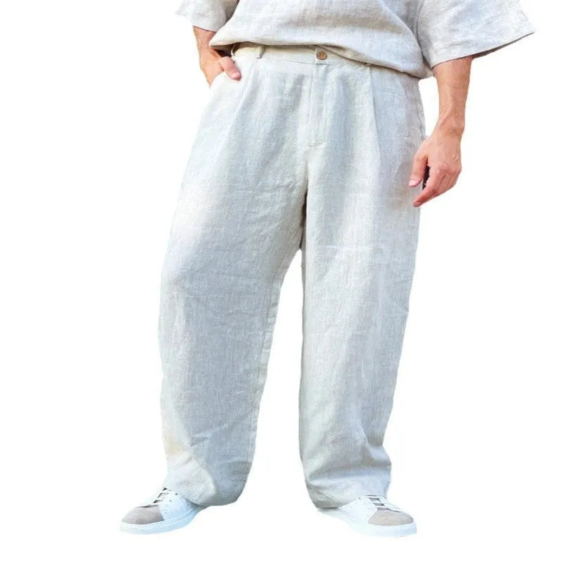 Men's loose fit pleated high waist jogger pants in a light grey colour, showing the casual straight-leg style.