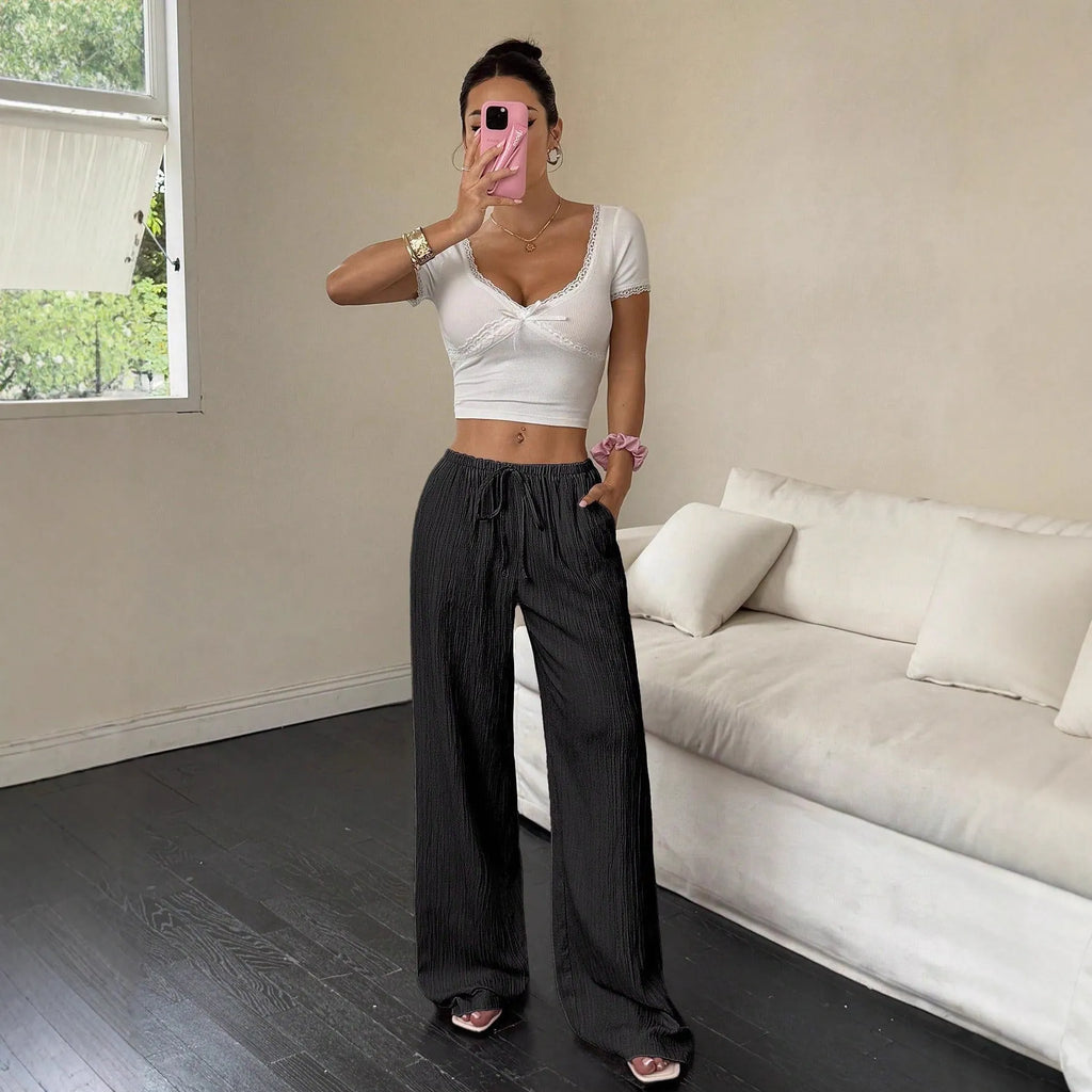 Women's black wide-leg trousers with lace-up waist detailing and mid-rise fit