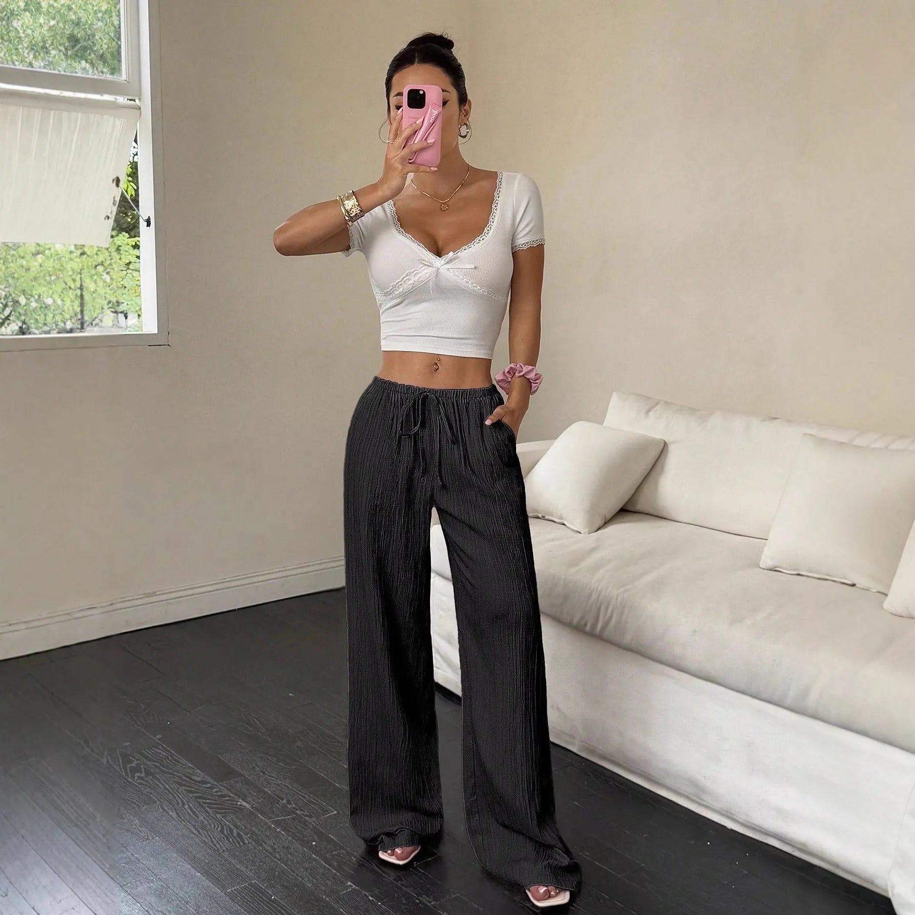 Women's black wide-leg trousers with lace-up waist detailing and mid-rise fit