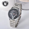 Steering wheel fashion watch with 43mm circular alloy case, stainless steel strap, and pointer display on a light background.