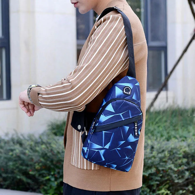 Medium blue crossbody chest bag for men with a visible earphone hole and zipper opening.