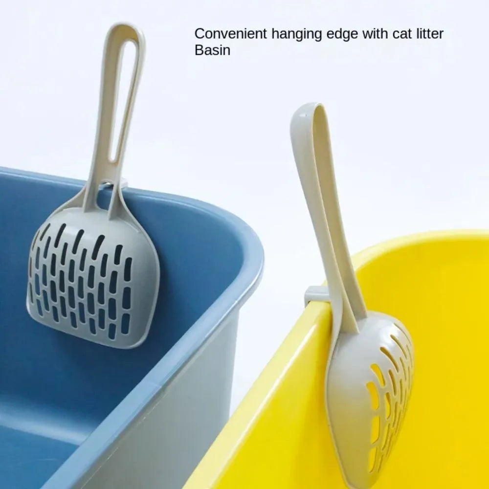 Grey plastic cat litter scoop standing upright in its attached storage base