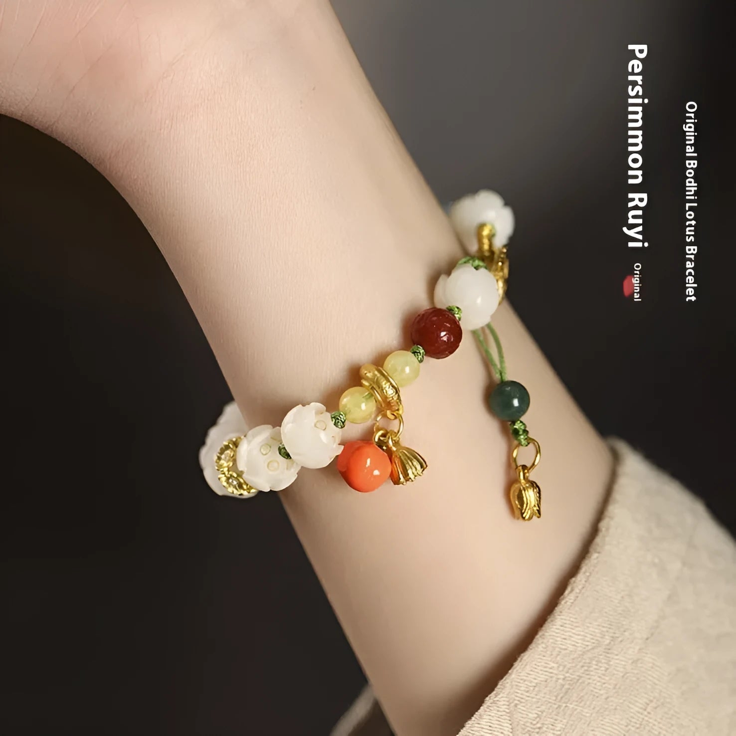 Close-up of a hand-woven white jade Bodhi bracelet with pumpkin and lotus beads on an adjustable rope.