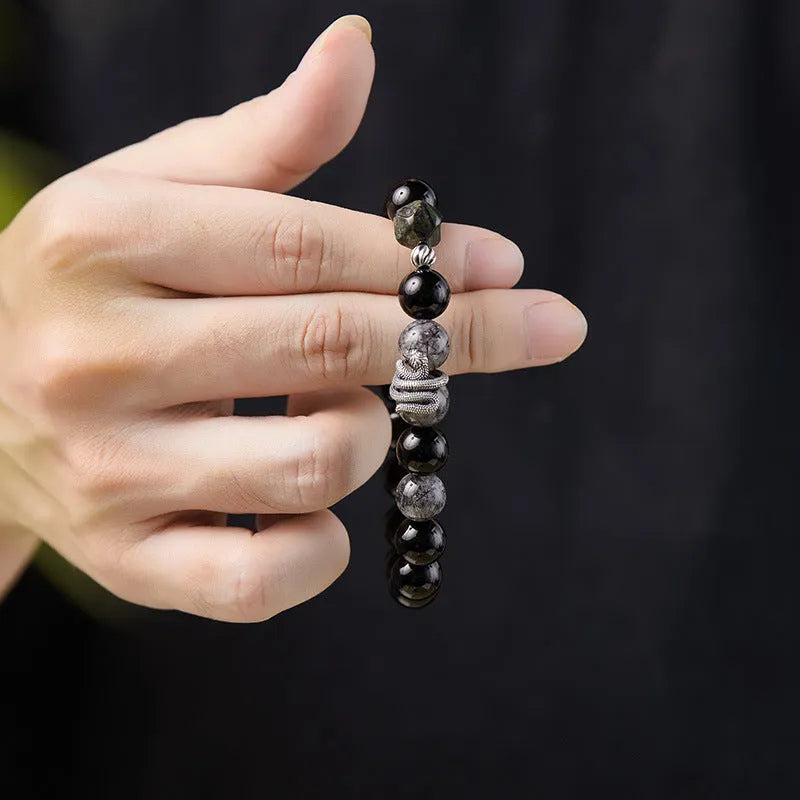 S925 sterling silver men's bracelet with black obsidian crystal and detailed snake design on a wrist.