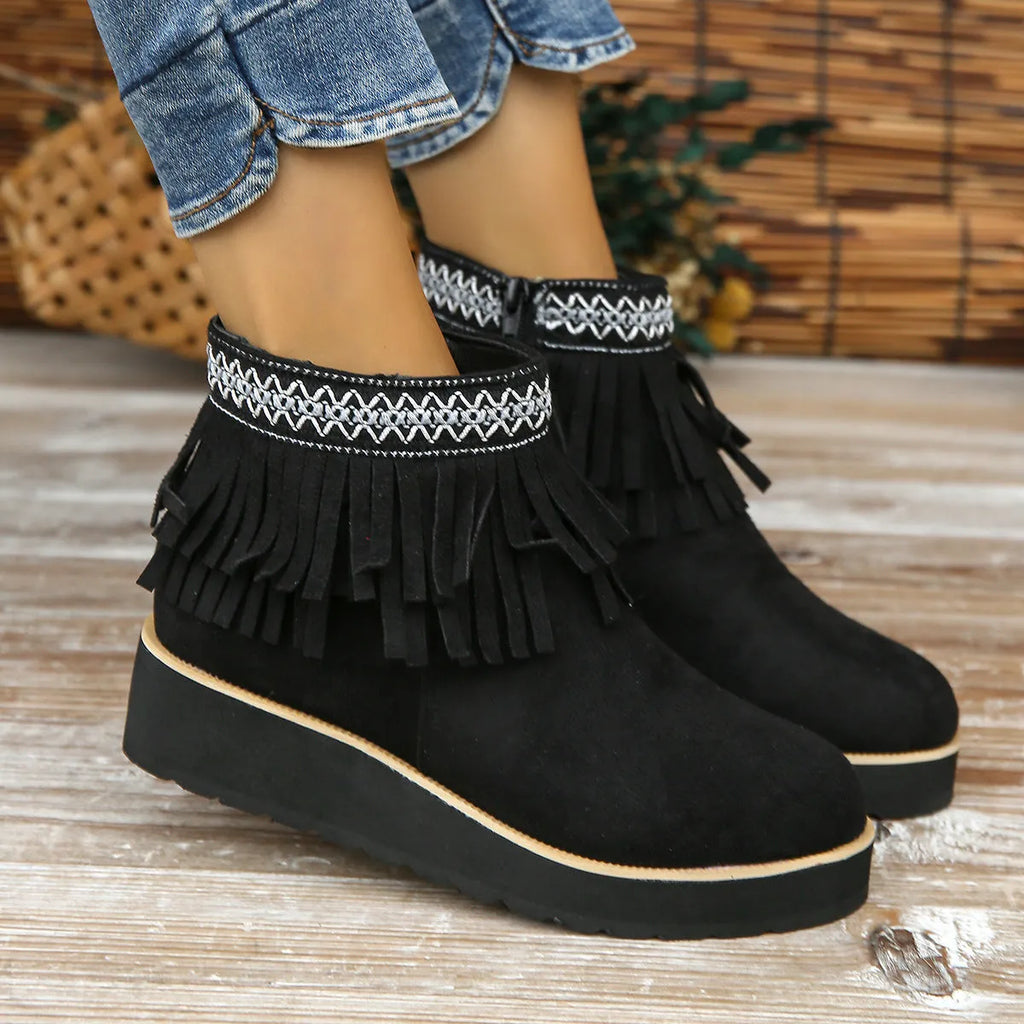 Women's dark brown suede ankle boots with wedge heel, platform sole, side zip, and tassel detail.