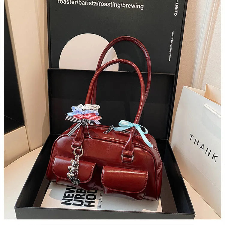 Women's brown PU leather retro pillow handbag with flap and ribbon pendant carried on shoulder