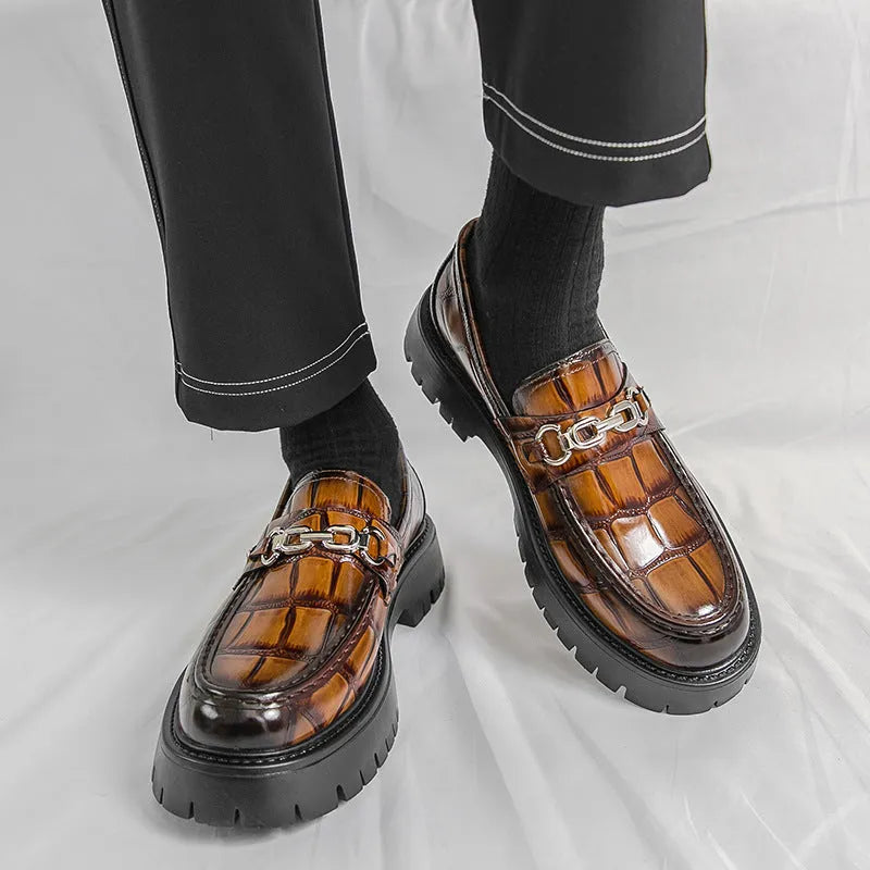 Men's black crocodile pattern leather loafers with a flat heel.