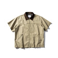Man wearing a grey washed cotton short sleeve loose cardigan shirt.