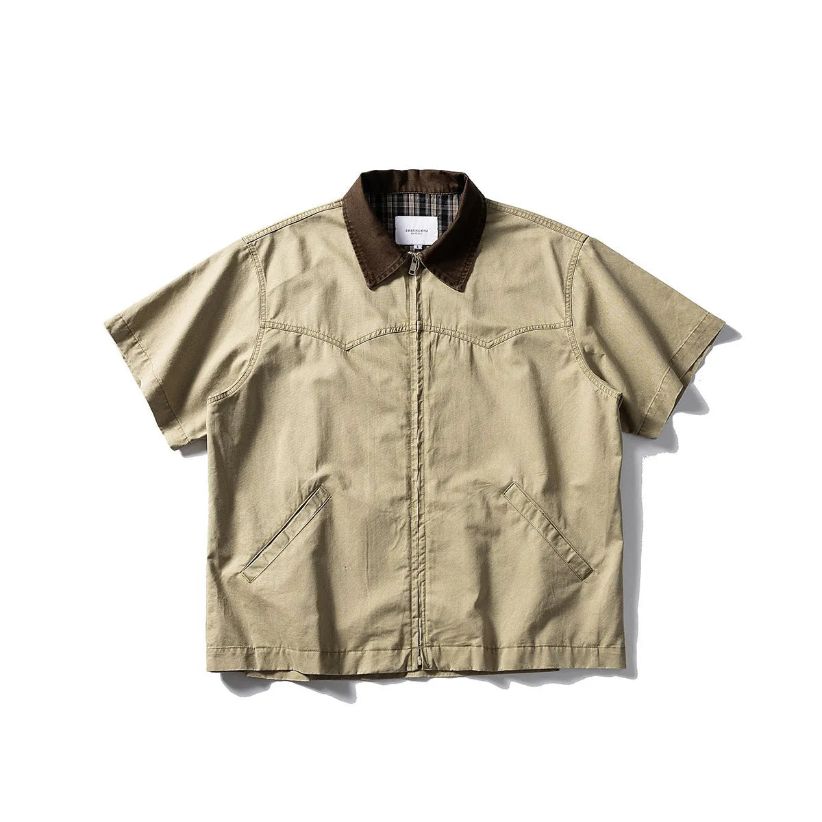 Man wearing a grey washed cotton short sleeve loose cardigan shirt.