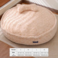 Round nest pet bed with a removable cover in a milk tea colour on a wooden floor