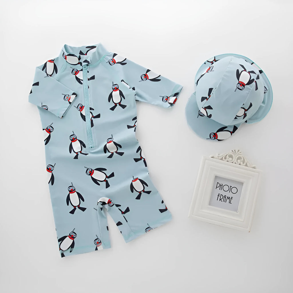 Boys' blue penguin print swim set with long sleeve swimsuit and matching swimming cap