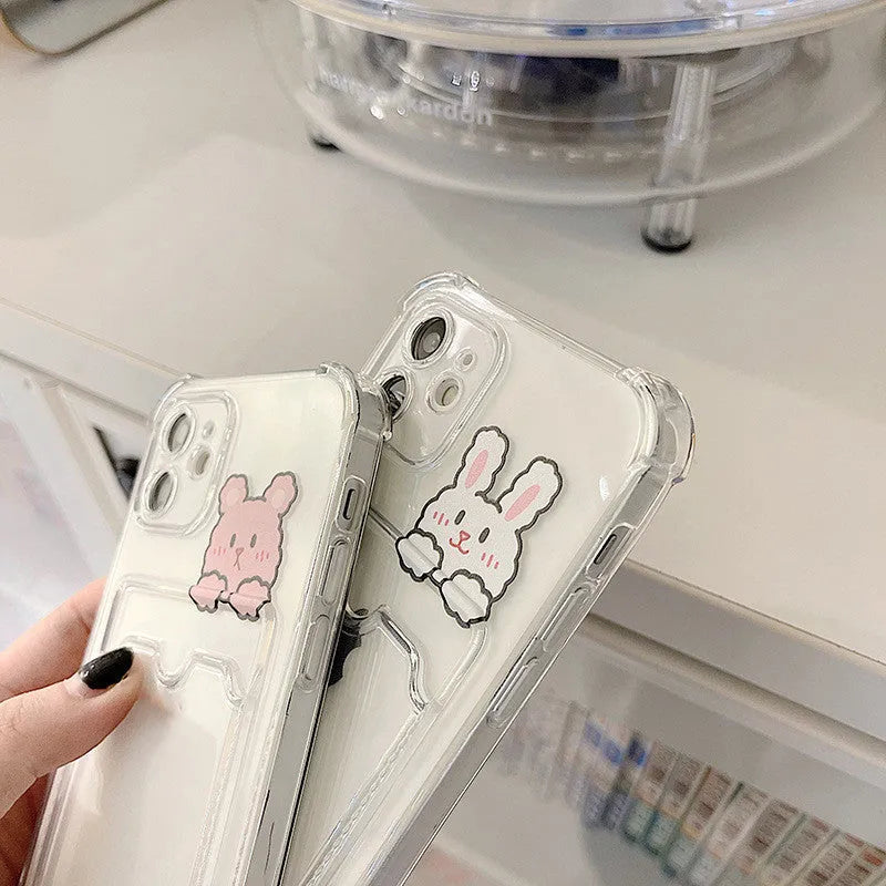 Clear cartoon-patterned iPhone case with a built-in card holder on the back.