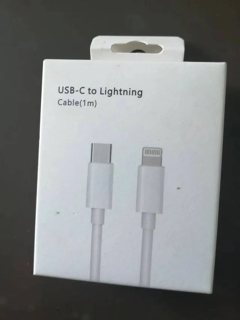 White 20W USB-C PD fast charger with UK plug and a coiled charging cable.