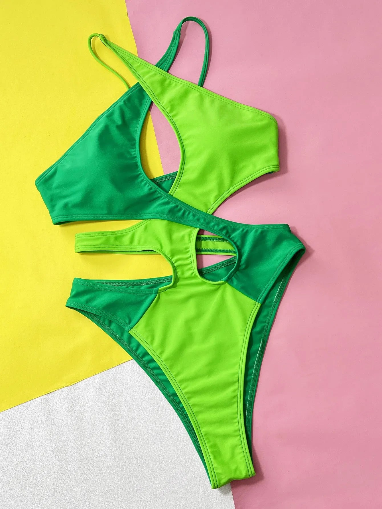 Green women's one-piece swimsuit with a hollow contrast colour design
