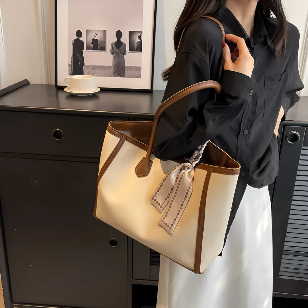 Soft PU leather square tote shoulder bag in black showing open outer pocket and internal phone compartment.