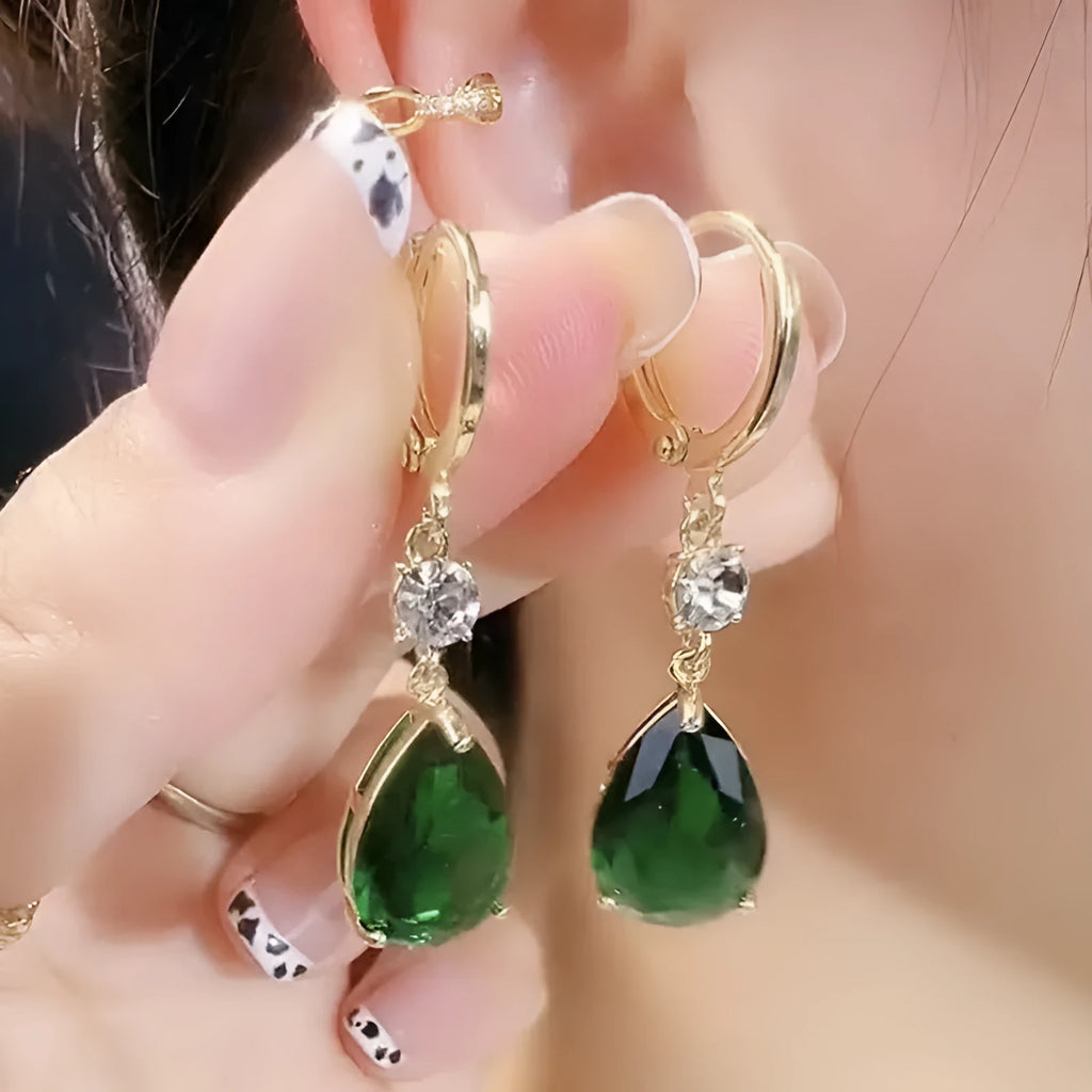 A pair of geometric green teardrop-shaped alloy drop earrings on a white background.