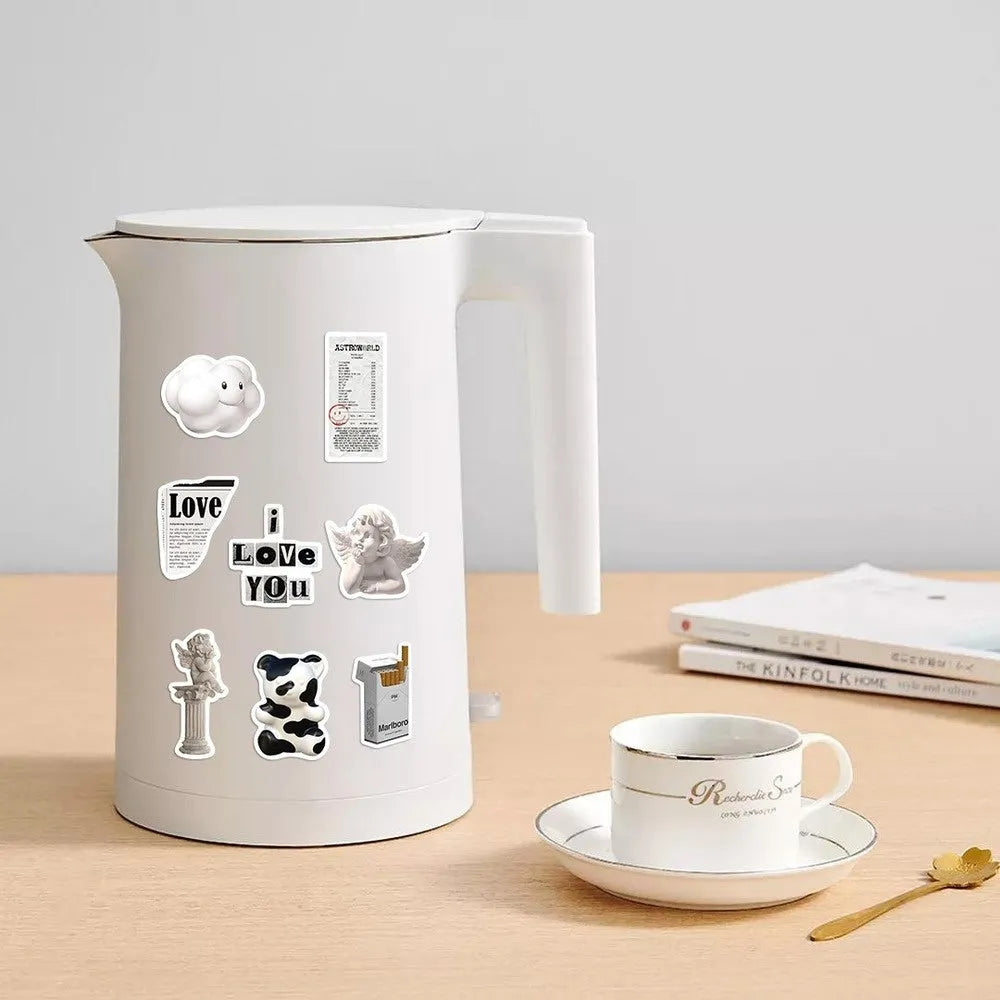 Assortment of black and white vinyl stickers featuring coffee cups and abstract designs for laptops and phones.