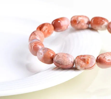 Natural cherry agate bracelet with 10x14mm barrel beads and Ruyi geometric elements