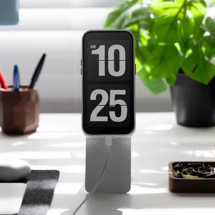 Black magnetic mobile phone holder case on a car dashboard, showing compact size and magnetic plate.