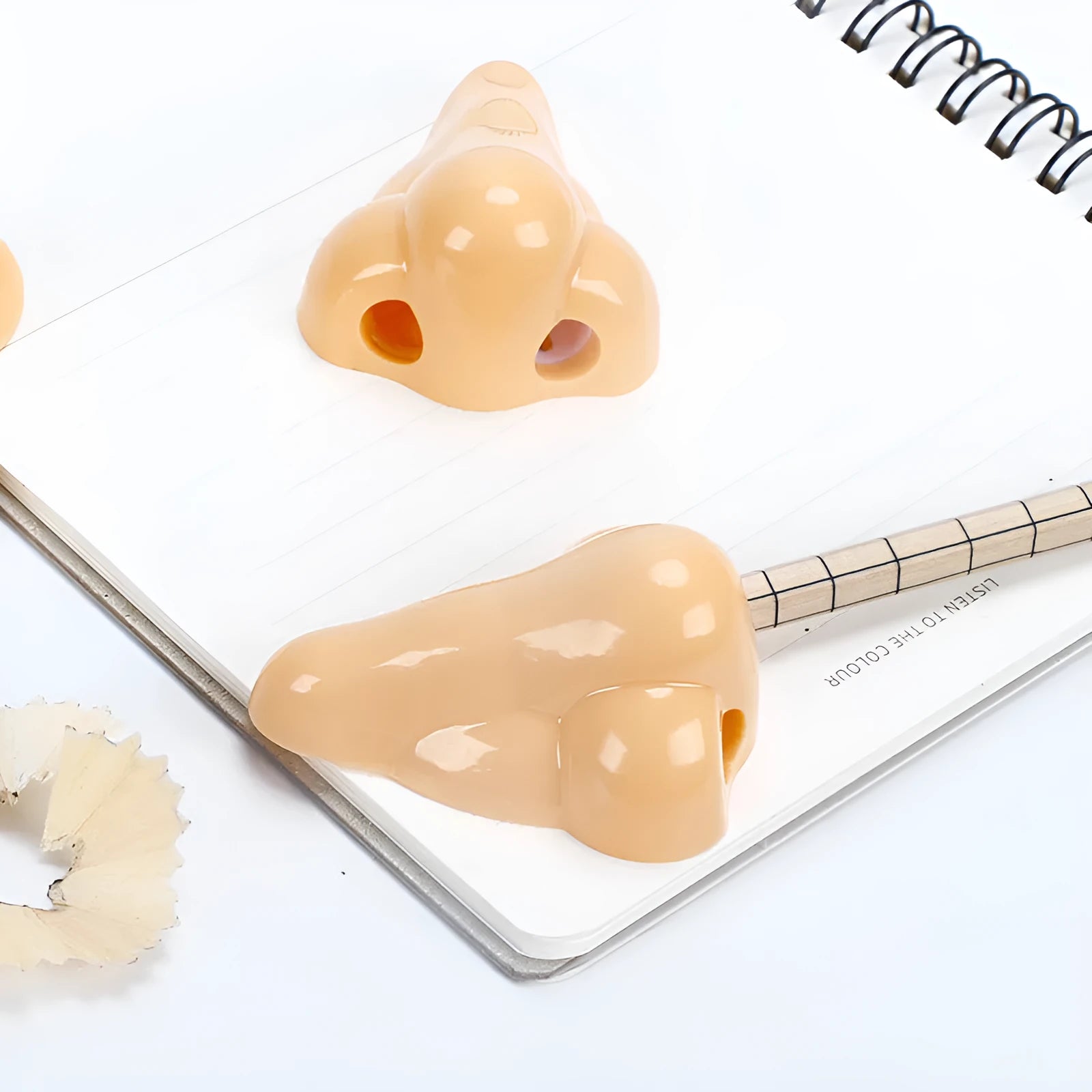 Flesh colour plastic pencil sharpener with large nostril design measuring 58x45x30mm