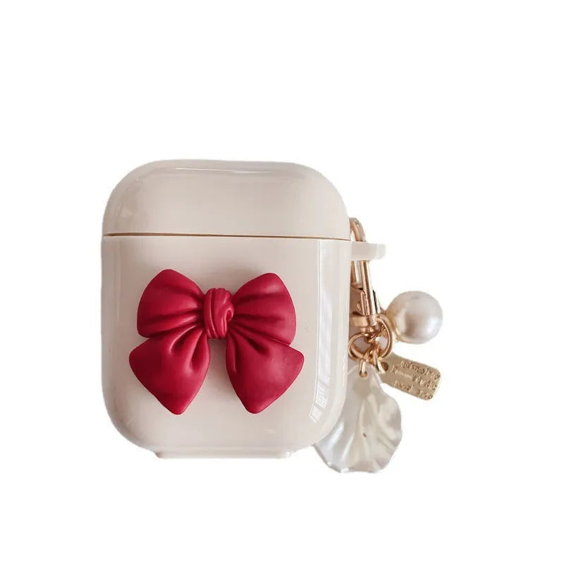 Beige AirPods case with red bow decoration, clamshell design for AirPods Pro and AirPods 3 models
