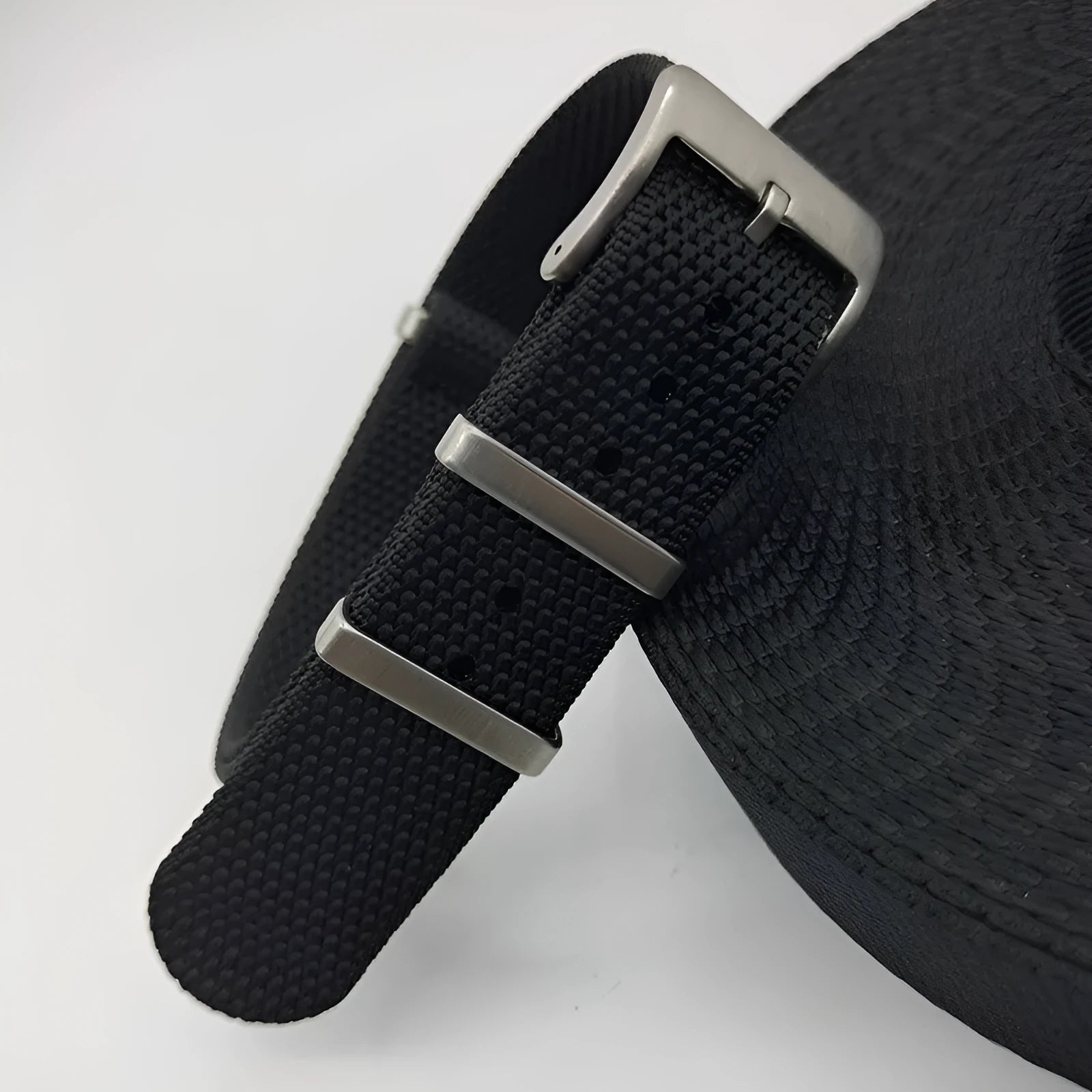 Nylon integrated watch strap in military colours showing integrated design without separate buckles