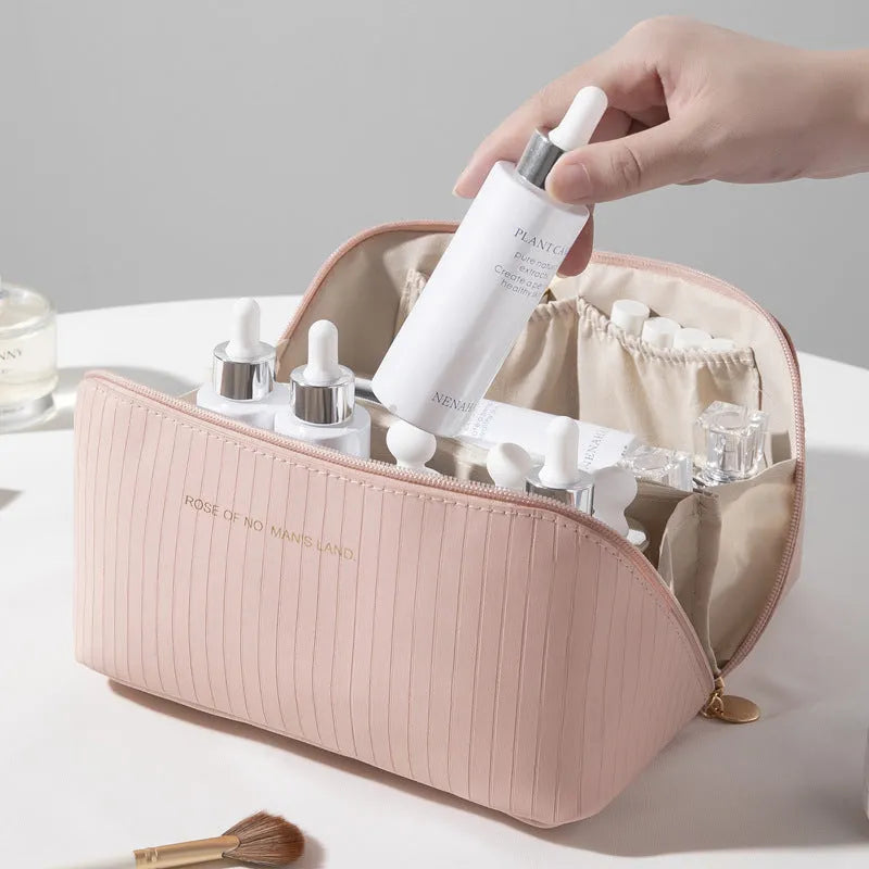 Vertical pattern cubic PU leather makeup bag in beige, shown open to display large capacity interior.