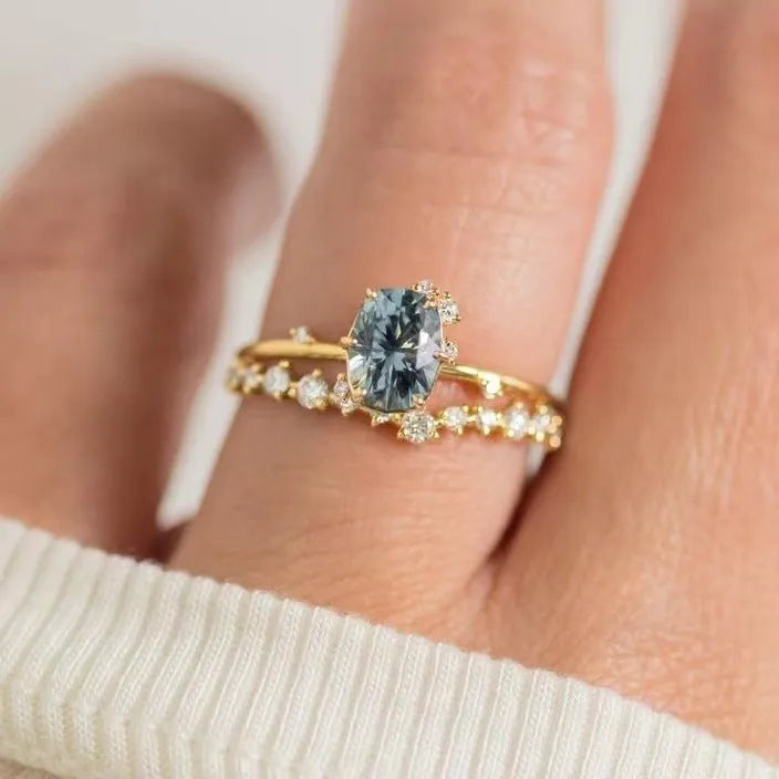 Gold plated floral fashion ring with green zircon stone inlay on finger