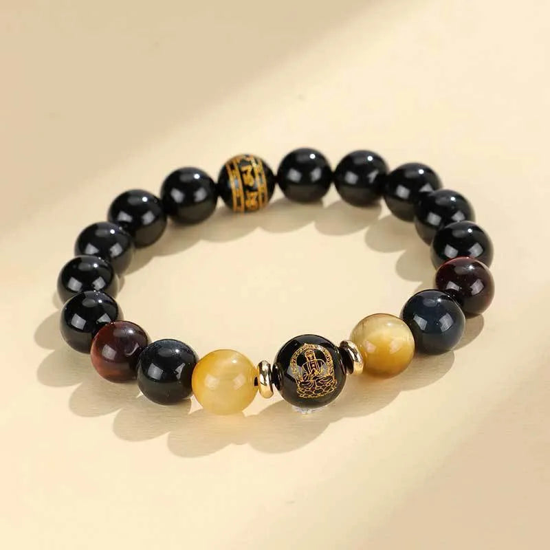 Black agate beaded bracelet with carved Buddhist charm and tiger eye stones