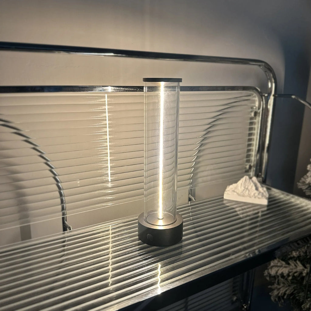 Slim warm white LED light strip with magnetic base for USB charging and attachment to metal surfaces.