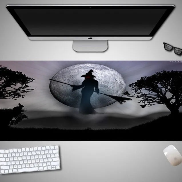 Oversized Halloween-themed mouse pad with non-slip rubber base on a desk.