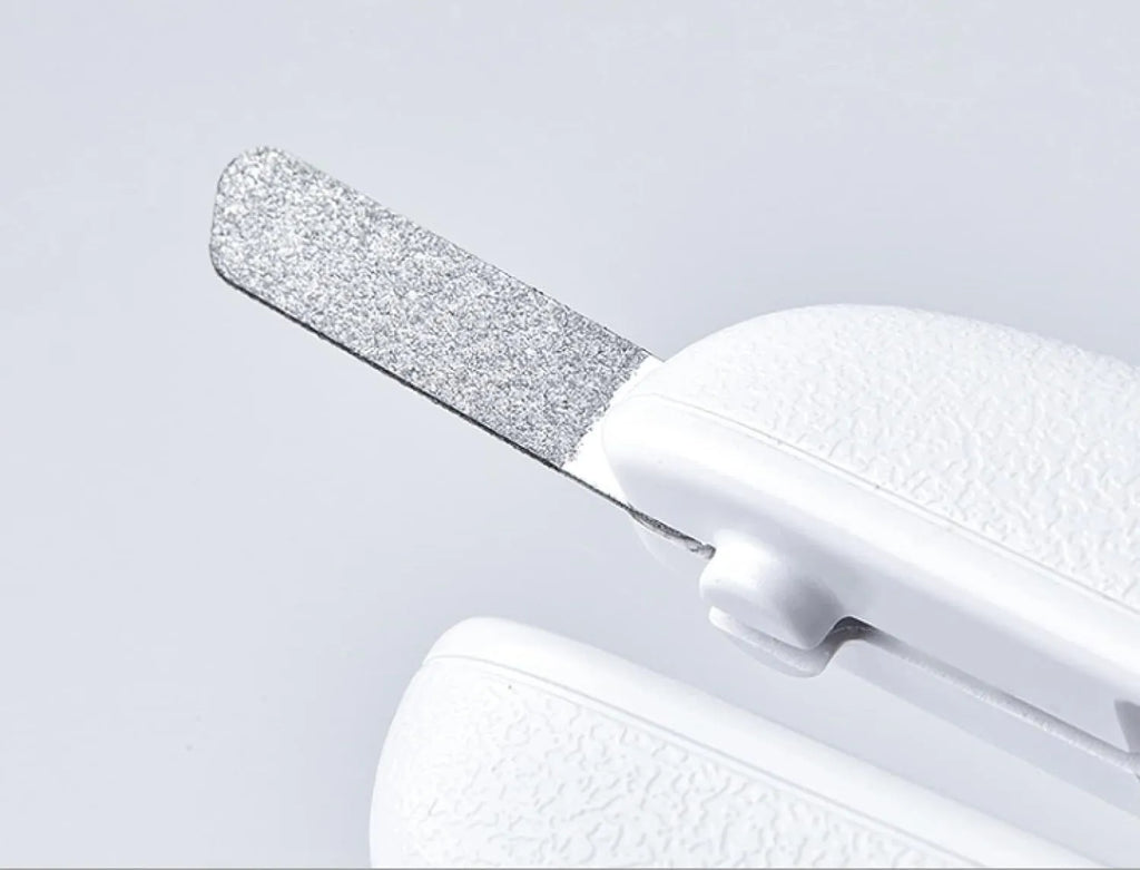 White pet nail clippers with LED light on blade and transparent anti-splash guard, shown with a nail file.