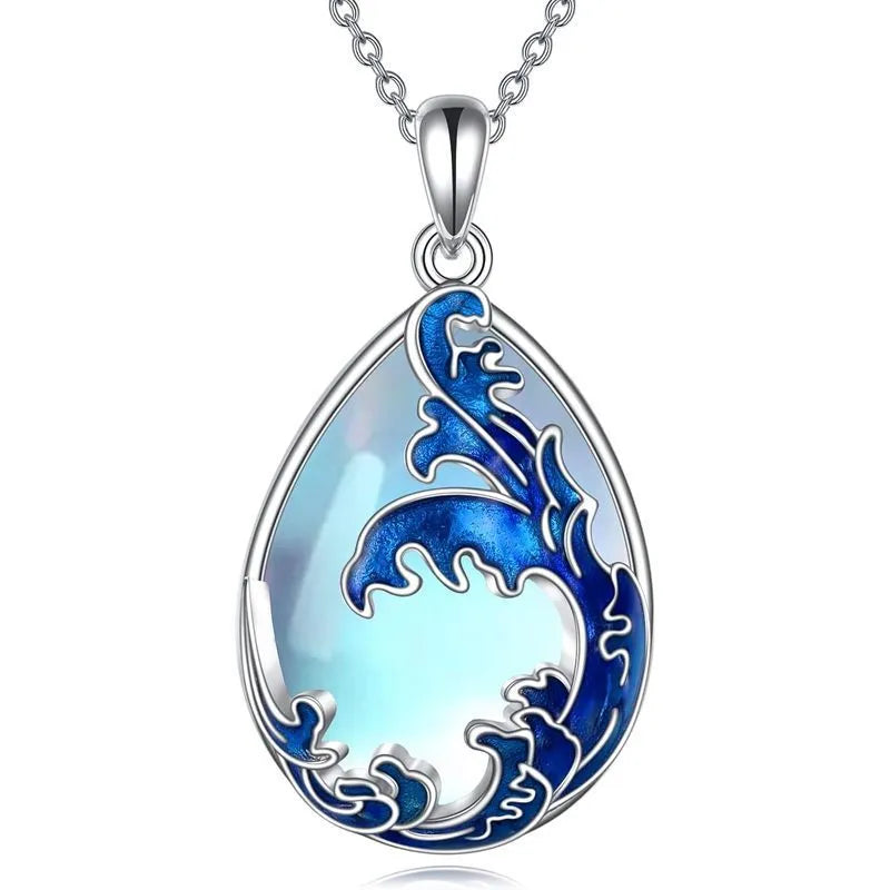 Close-up of a moonstone blue heart-shaped alloy pendant on a necklace chain.