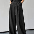 Men's black vertical striped pleated casual trousers showing front design and fabric texture