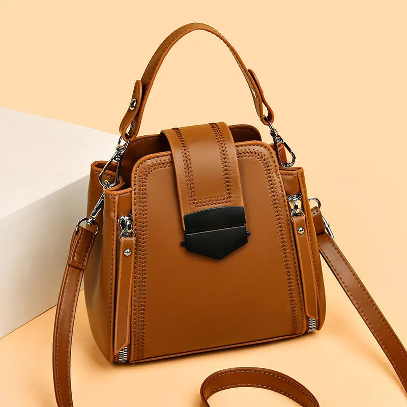 Small square vertical handbag in soft textured PU leather with sewing thread detail.