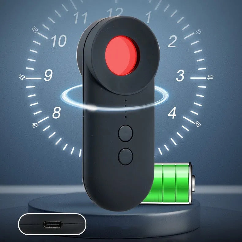 Black portable GPS and hidden camera detector with USB charging cable on a grey background.