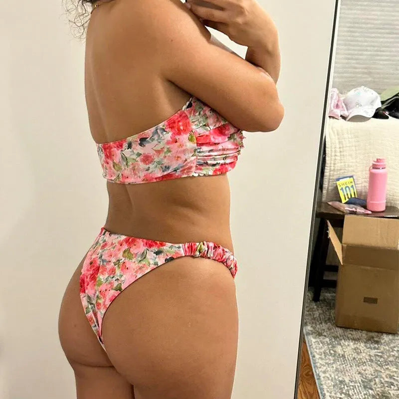 Women's floral print bikini set with lace trim on a backless tube top and matching briefs.